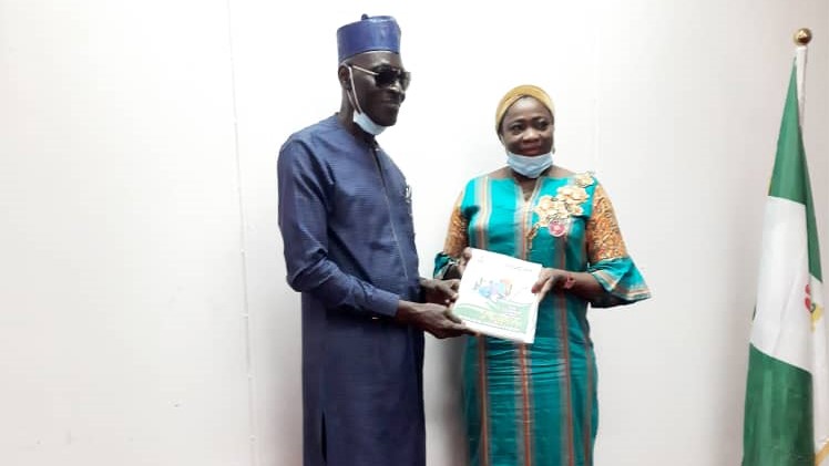 L-R The Gambia High Commissioner to Nigeria H.E Amadou Taal. and the Chairman/CEO, NiDCOM Hon. Abike Dabiri-Erewa giving out a copy of NIDCOM publication during the courtesy visit in Abuja on Thursday. NIDCOM Media Photo.