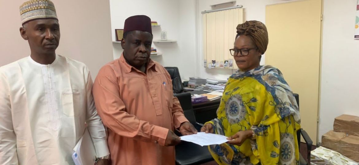 Mother of Mr Abdulsamad Abubakar presenting the written petition in Abuja on Friday