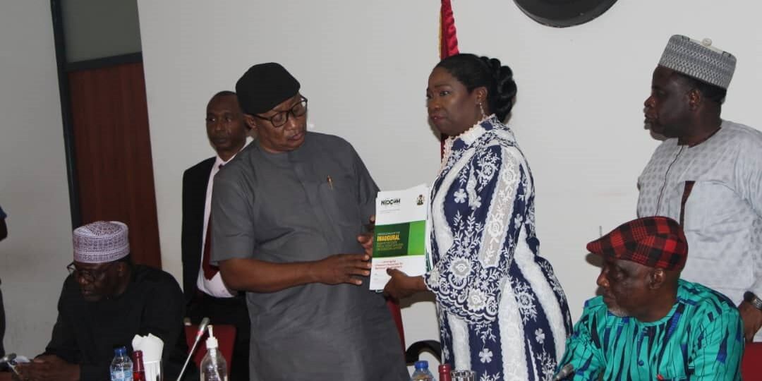 Hon. (Dr) Abike Dabiri-Erewa, Chairman/CEO, Nigerians in Diaspora Commission presented some copies of published books and journals on the activities of the Commission to the Senate Committee Chairman on Diaspora, NGOs and Civil Society, Sen.Michael Ana-Nnachi while Sen. Abba Moro, a member of the committee looks on.