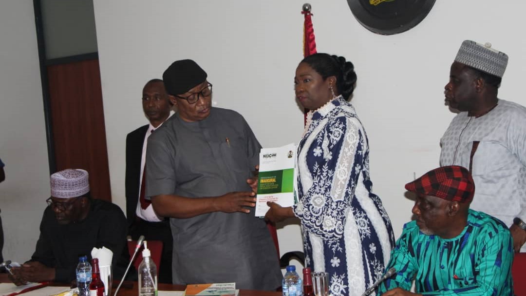 Hon. (Dr) Abike Dabiri-Erewa, Chairman/CEO, Nigerians in Diaspora Commission presented some copies of published books and journals on the activities of the Commission to the Senate Committee Chairman on Diaspora, NGOs and Civil Society, Sen.Michael Ana-Nnachi while Sen. Abba Moro, a member of the committee looks on.